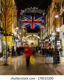 LONDON, UK - 24TH FEB 2014: Carnaby Street At Night With The Blur Of People Walking Past