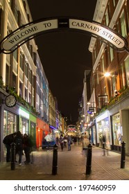 LONDON, UK - 24TH FEB 2014: Carnaby Street At Night With The Blur Of People Walking Past