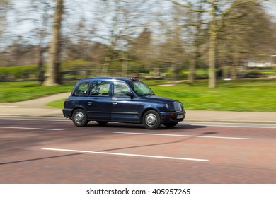 LONDON, UK - 27TH MARCH 2015:  A Side View Of A Typical Black Cab In London During The Day. A Driver Can Be Seen.