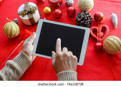 London, UK - 28 October 2017: Closeup On Person Hands Using Apple Ipad 2 Smart Tablet At Christmas Festive Table Background. Communication Technology Mockup Abstract Background. Joyful Happy Fun Time