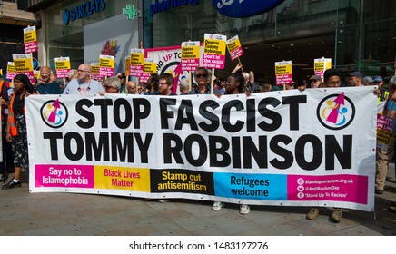 London, UK. 3rd August 2019. Anti-Fascist campaigners with large banner at the "Oppose Tommy Robinson" counter demonstration, in protest of a march being held by far-right supporters of Mr Robinson.