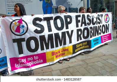 London, UK. 3rd August 2019. Anti-Fascist campaigners with large banner at the "Oppose Tommy Robinson" counter demonstration, in protest of a march being held by far-right supporters of Mr Robinson.
