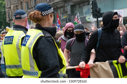 London, UK. 3rd August 2019. Anti-Fascist campaigners watched by police at the "Oppose Tommy Robinson" counter demonstration, in protest of a march being held by far-right supporters of Mr Robinson.