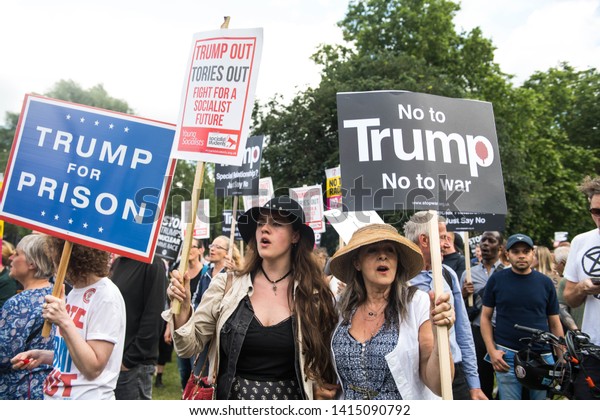 London,\
UK. 3rd June, 2019. Anti-Trump demonstrators hold placards as they\
protest outside of Buckingham Palace, On the first day of the US\
president and First Lady\'s three-day State\
Visit.