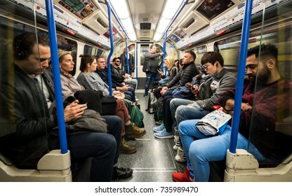 LONDON, UK - 5 OCTOBER 2017: London Underground Tube Train Passengers. An Interior View Of A Busy Piccadilly Line London Tube Train Filled With Commuters And Tourists.