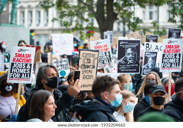 London, UK. 6th June 2020. Anti-racism\
campaigners holding signs, at the Black Lives Matter demonstration\
in London, in protest of the death of Black American George Floyd\
by US police in\
Minneapolis.