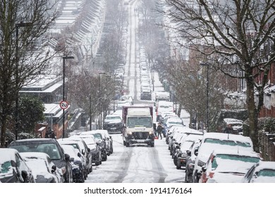 London, UK - 9 February, 2021 - Ocado Food And Grocery Delivery Van Driving On A Road Under Snowstorm