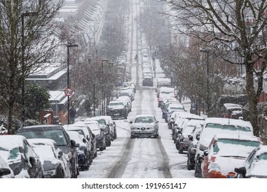 London, UK - 9 February, 2021 - A Car Driving On A Road Under Snowstorm In Crouch End, Adverse Driving Conditions