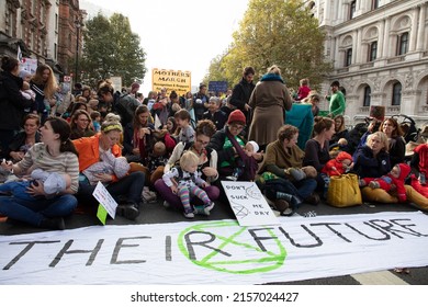 London, UK. 9th October 2019. Protesters in the Mothers March and nurse-in; mothers and babies seen sitting on the street Whitehall, London, during the Extinction Rebellion two week long protest.