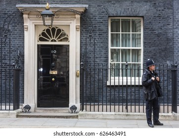 LONDON, UK - Apr 19, 2017: Metropolitan police officer on duty at 10 Downing Street official residence of First Lord of the Treasury, headquarters of Her Majesty's Government, office of Prime Minister