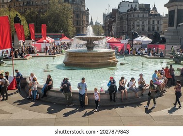 London, UK - Apr 19, 2019 : Busy Afternoon At Trafalgar Square. Locals And Tourists Visiting Sit By Fountain In Trafalgar Square. Trafalgar Square Is A Public Space And Tourist Attraction In Central.