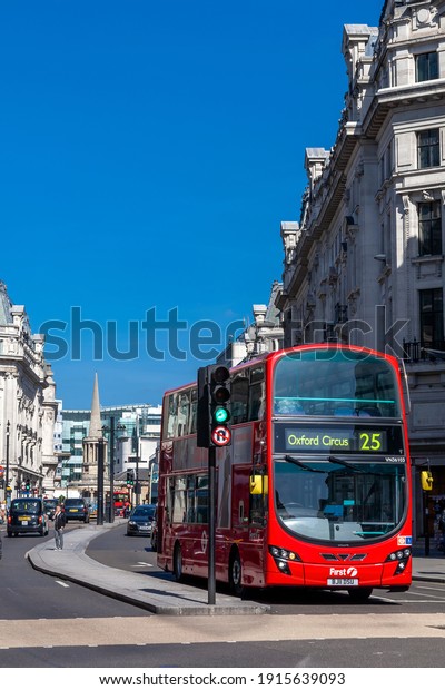 London, UK, April 1, 2012 : New modern\
Routemaster double decker red bus in New Oxford Street which is\
part of the cities public transport infrastructure and is a popular\
travel destination\
attraction
