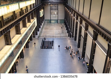 LONDON, UK - APRIL 1, 2019: People Walking In Interior Of Tate Modern Turbine Hall In London