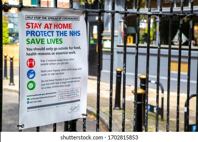 London / UK - April 13th 2020: Southwark Local Council Covid 19 Coronavirus Sign - Stay At Home - Protect The NHS - Save Lives. On A Metal Fence With A Closed Pub In The Background