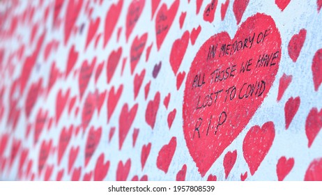 London, UK - April 17, 2021: The National Covid Memorial Wall, Volunteers Painting 150,000 Red Hearts To Commemorate Covid-19 Deaths