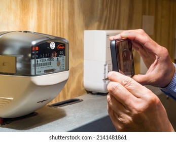 London, UK, April 1st 2022: Taking A Mobile Photo Of An Electricity Meter. Actual Reading For Energy Suppliers During High Fuel Costs, Price Rises And Price Cap. Cost Of Living.