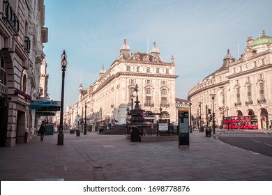 London, UK - April 2020: Piccadilly Circus During Coronavirus Lockdown. Stay Home Sign. NHS Support. Iconic London Landmark With Famous Billboard And Traditional London Bus.