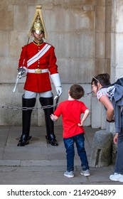 London, UK - April 20th 2022: A child and his mother looking at a Queen’s Life Guard, pictured at Horse Guards Parade in Westminster, London, UK.