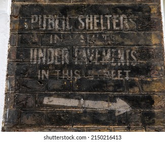 London, UK - April 20th 2022: Historic ghost signs on a street in Westminster, London, dating from the 2nd World War, informing the location of the nearest Air Raid Shelter.  