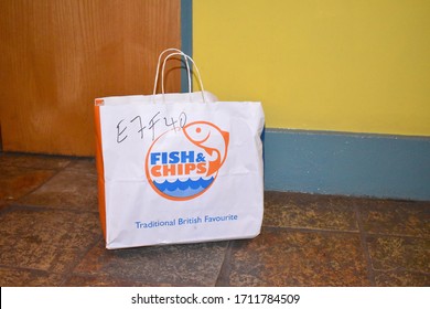 London, UK - April 21 2020: Takeaway Dinner Delivered Contact Free From Local Restaurant Traditional British Deep Fried Seafood Battered Haddock And Scampi With Fresh Cut Chips Mushy Peas And Coleslaw