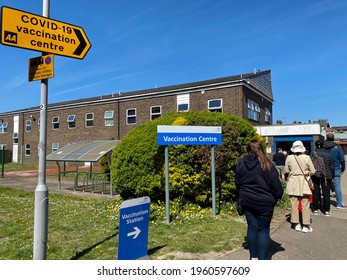 London, UK - April 22, 2021: Peole In The Queue For COVID19 Vaccine In Front Of A Vaccination Centre. 