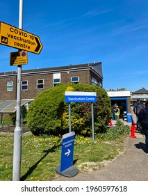 London, UK - April 22, 2021: Peole In The Queue For COVID19 Vaccine In Front Of A Vaccination Centre. 
