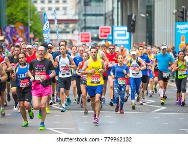 London, UK - April 23, 2017: Lots of people running in London Marathon. People cheering the sportsmen in Canary Wharf aria