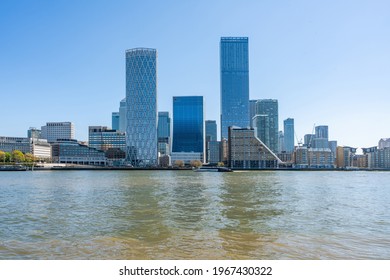 LONDON, UK - APRIL 23, 2021: Modern skyscrapers of Canary Wharf, the financial hub in London seen across the River Thames