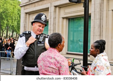 LONDON, UK - APRIL 29: A Policeman Talking To People At Prince William And Kate Middleton Wedding, April 29, 2011 In London, United Kingdom