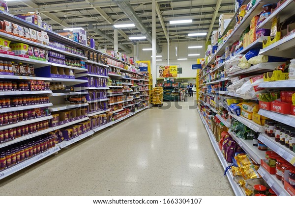 London, UK - April 4, 2019: Food items are seen in\
a Tesco supermarket store aisle. Tesco is the world\'s second\
largest retailer with 7,817 stores worldwide and a revenue of £62.3\
billion in 2015.