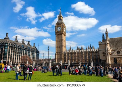 London, UK, April 6, 2012 : Parliament Square with tourists showing Big Ben of the Houses of Parliament and Portcullis House which is a popular tourism travel destination landmark, stock photo image