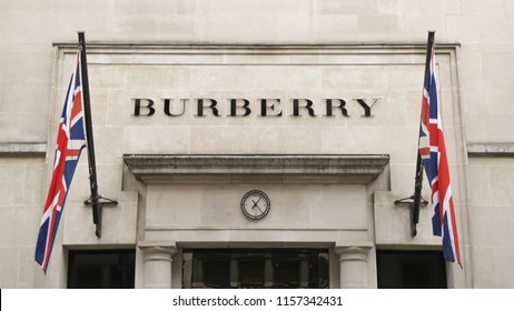 LONDON, UK - AUGUST 15, 2018: A View Of British Burberry Fashion Shop On Bond Street, Mayfair In London. A High End British Brand Selling Expensive Luxury Fashion Items. UK Flags Next To The Logo. 