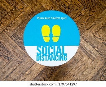 London UK, August 16th 2020: "Social distancing" floor sticker sign in shopping mall. Stratford Westfield, East London. Social distancing measures during Covid-19, Coronavirus pandemic. 