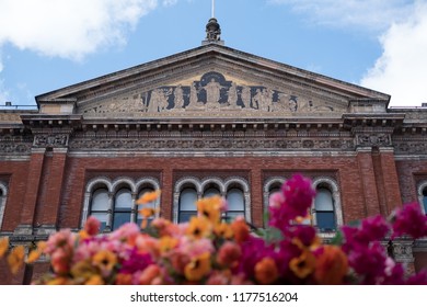 London UK, August 2018. John Madejski Garden At The Victoria And Albert Museum. Photo Shows Facade Of The Lecture Theatre Block With Flowers In Foreground, A Theme From The Frida Kahlo Exhibition.