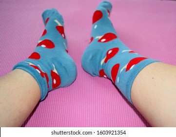 London UK, August 2019: Colourful Tennis Socks On Female Hairy Legs On Pink Background.