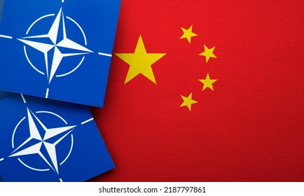 LONDON, UK - August 2022: NATO North Atlantic Treaty Organization Military Alliance Logo On A China Flag