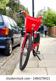 LONDON, UK - AUGUST 21, 2019: A Jump Dockless Electric Bicycle Parked On The Pavement In A Street In North London, UK.