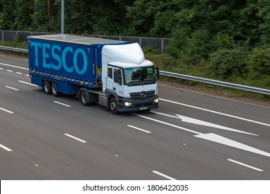 LONDON, UK - AUGUST 31, 2020: Lorry belonging to Tesco, largest British multinational groceries and general merchandise retailer travelling on British motorway M25.
