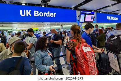 London, UK- August 6, 2021: Air Travelers With Face Mask Queuing At UK Border Control In Heathrow Airport, London. 