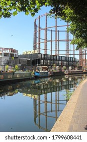London / UK - August 7 2020: Regent's Canal Walk in East London featuring gas storage tank and 'Containerville' near Victoria Park