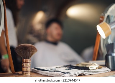 London UK - August 7, 2021:  Hairstylist Doing Haircut In Mobile Hair Salon At Classic Car Boot Sale, A Retro Culture Festival.