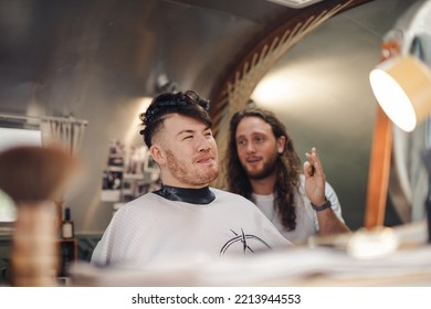 London UK - August 7, 2021:  Hairstylist Doing Haircut In Mobile Hair Salon At Classic Car Boot Sale, A Retro Culture Festival.