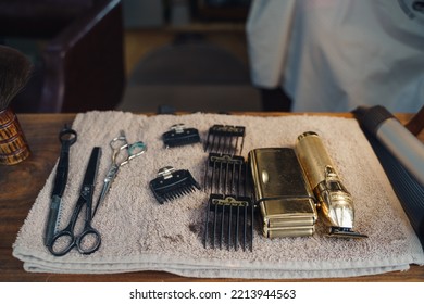 London UK - August 7, 2021:  Hairstylist Doing Haircut In Mobile Hair Salon At Classic Car Boot Sale, A Retro Culture Festival.