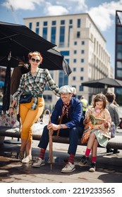 London UK - August 7, 2021: Stylish Family Having Fun At The Classic Car Boot Sale, A Retro Culture Festival.