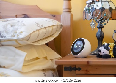 London, UK - Circa April 2020: Traditional Bedroom Interior Showing A Floral Design, Summer Duvet And Pillows. A Popular Smart Home Speaker And Display On The Bedside Table Shows The Current Weather.