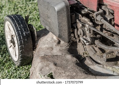 London, UK - Circa April 2020: Heavy Grimed Up And Dirty Petrol Mower Engine, Prior To Its Annual Service. Fibre Glass Has Been Used On Parts Of The Heavily Corroded Metal Chassis.