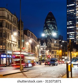 LONDON, UK - CIRCA JUNE 2015: Traffic And Gherkin Building In The Background At Night. The Gherkin Has Become An Iconic Symbol Of London. 