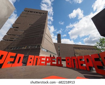 LONDON, UK - CIRCA JUNE 2017: Sculpture named Forward by artist Eric Bulatov in front of the Tavatnik Bulding at Tate Modern art gallery in South Bank power station