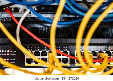 London, UK - Circa March 2019: Shallow focus of a newly installed, Gigabit core switch with PoE functionality. Various patch cables of different colours are seen connected. Located in a data centre.