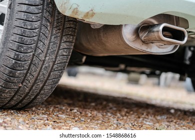 London, UK - Circa November 2019: Ground Level View Of A New Car, Showing The Rear Tyre And Tread Together With Its Exhaust System And Composite Rear Bumper.